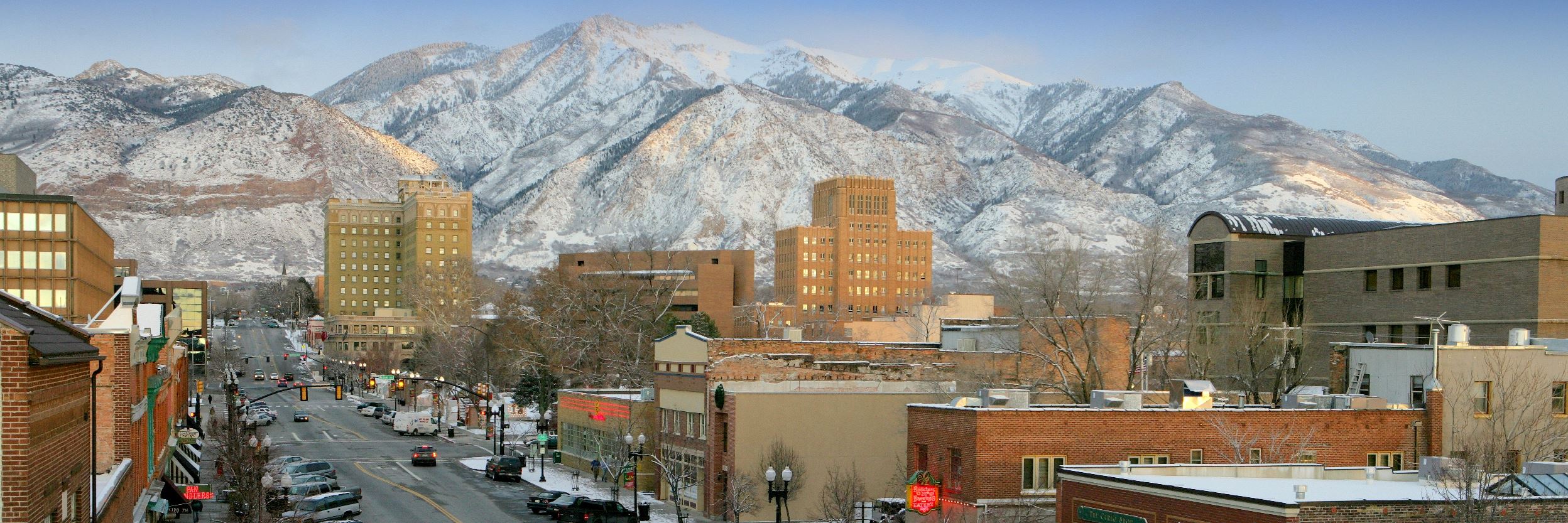 A street view of Ogden City with mountains in the background